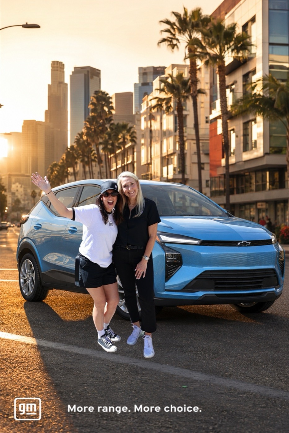 Two guests cleanly cut out and placed on a sunset LA street in front of a GM electric vehicle
